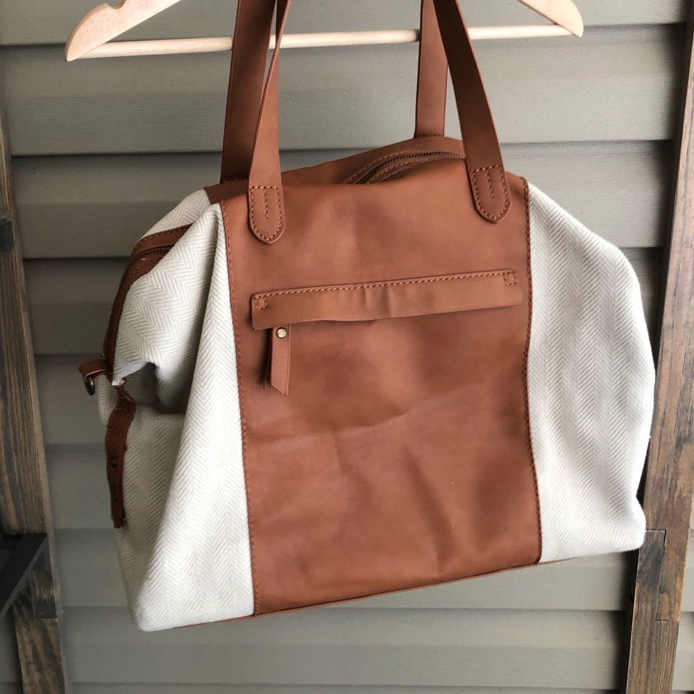Leather and cream duffel bag